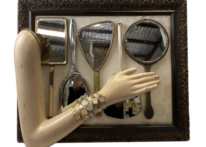 Frame with five handheld mirrors within it and a maniquin arm