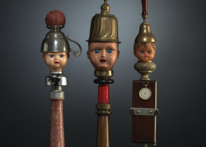 three sculptures made out of lamps and dolls heads