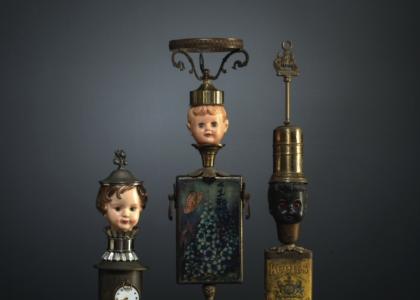 three sculptures made out of lamps and dolls heads